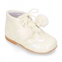 Classic patent leather English style bootie for first steps with POMPONS.