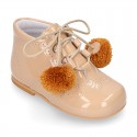 Classic patent leather English style bootie for first steps with POMPONS.