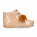 Classic patent leather English style bootie for first steps with POMPONS.