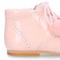 Classic patent leather English style bootie for first steps with POMPONS.