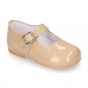 Classic patent leather little Mary Janes with perforated flower design.