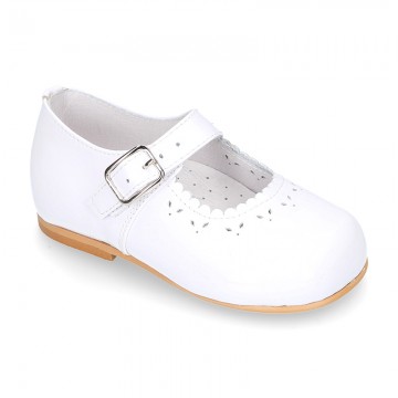Classic patent leather little Mary Janes with perforated flower design.