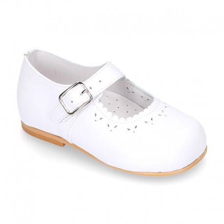 Classic patent leather little Mary Janes with perforated flower design.
