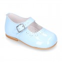 Classic patent leather little Mary Janes with perforated flower design.