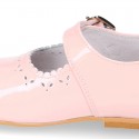 Classic patent leather little Mary Janes with perforated flower design.