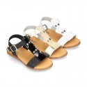 Combined leather sandals with patent and metal details finish.