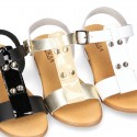 Combined leather sandals with patent and metal details finish.