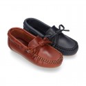 Tanned leather Moccasin shoes with bows.