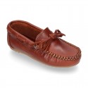 Tanned leather Moccasin shoes with bows.