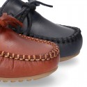 Tanned leather Moccasin shoes with bows.