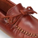 Tanned leather Moccasin shoes with bows.