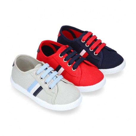 New cotton canvas tennis shoes with flag detail.