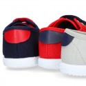 New cotton canvas tennis shoes with flag detail.