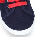 New cotton canvas tennis shoes with flag detail.