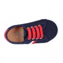 New cotton canvas tennis shoes with flag detail.