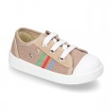 Cotton canvas sneakers with zipper and ties closure and toe cap.