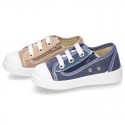 Cotton canvas sneakers with zipper and ties closure and toe cap.