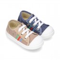 Cotton canvas sneakers with zipper and ties closure and toe cap.