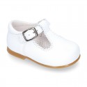 Classic Nappa leather T-strap shoes with buckle fastening.