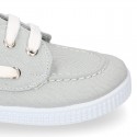 Cotton canvas boat shoes with ties closure.