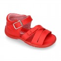 Washable leather sandal shoes with crossed strips and ribbon for little girls.