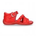 Washable leather sandal shoes with crossed strips and ribbon for little girls.