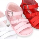 Washable leather sandal shoes with crossed strips and ribbon for little girls.