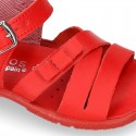 Washable leather sandal shoes with crossed strips and ribbon for little girls.