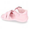 Washable leather sandal shoes with crossed strips and ribbon for little girls.