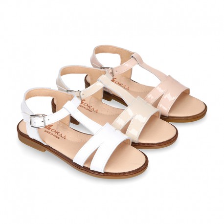 Patent Leather T-Strap Sandal shoes with crossed straps for girls.