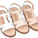 Patent Leather T-Strap Sandal shoes with crossed straps for girls.