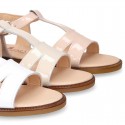 Patent Leather T-Strap Sandal shoes with crossed straps for girls.