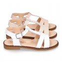 Patent Leather T-Strap Sandal shoes with crossed straps for girls.