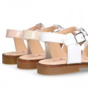 Patent Leather T-Strap Sandal shoes with crossed straps for girls.