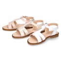 Patent Leather T-Strap Sandal shoes with crossed straps for girls.