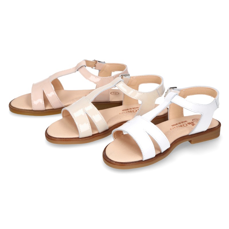 Patent Leather T-Strap Sandal shoes with crossed straps for girls.