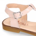 Patent Leather T-Strap Sandal shoes with crossed straps for girls.