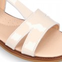 Patent Leather T-Strap Sandal shoes with crossed straps for girls.