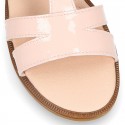 Patent Leather T-Strap Sandal shoes with crossed straps for girls.