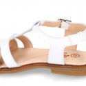 Patent Leather T-Strap Sandal shoes with crossed straps for girls.