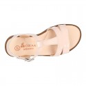 Patent Leather T-Strap Sandal shoes with crossed straps for girls.