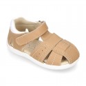 Washable leather kids sandal shoes with crossed straps and hook and loop strap closure.