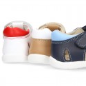 Washable leather kids sandal shoes with crossed straps and hook and loop strap closure.