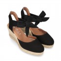 Wedge canvas sandal espadrille with buckle fastening in washing effect.