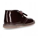 Classic Safari Boots with laces closure and waves in patent leather.