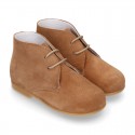 Classic suede leather ankle boots to dress for first steps.