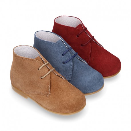 Classic suede leather ankle boots to dress for first steps.