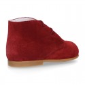 Classic suede leather ankle boots to dress for first steps.