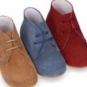 Classic suede leather ankle boots to dress for first steps.