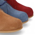 Classic suede leather ankle boots to dress for first steps.